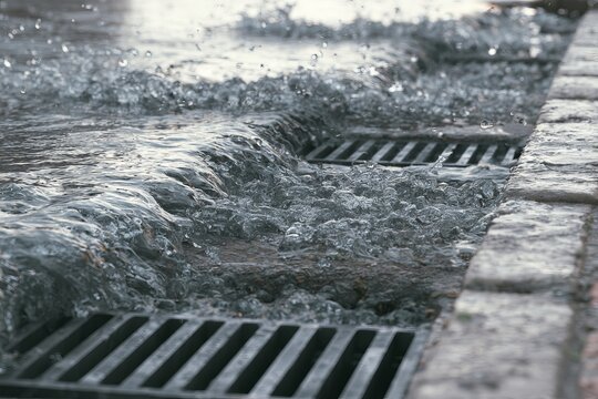 Rainwater flows into a drainage system during a rain event