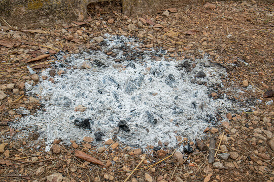 Small pile of wood ash on stony ground used for lye water in raisin processing