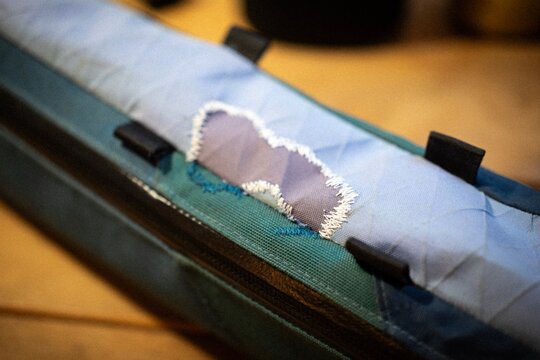 Close up of a sewn fabric patch on technical outdoor gear
