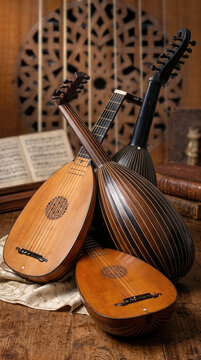 Renaissance and Baroque Lutes Still Life with Sheet Music and Carved Wooden Backdrop