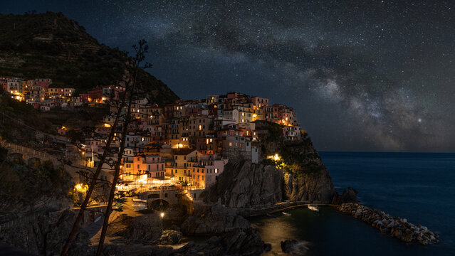 Manarola Cinque Terre Under Starry Night Sky with Illuminated Cliffside Village