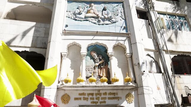 Sikh Manikaran Sahib Gurudwara Facade With Guru Statues and Religious Symbols