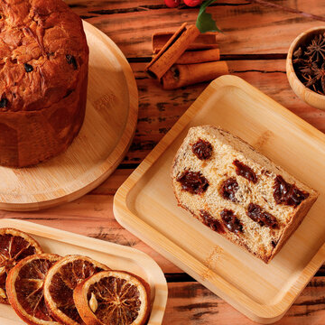 Sliced ​​chocolate panettone served as a special dessert on a rustic wooden surface.