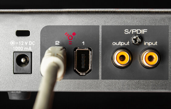Photo of a firewire sound board input connector sockets on black background.