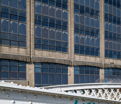 Gridded windows of a vacant office block located in the city of Aberdeen within Scotland under clear daylight showing architectural exterior details