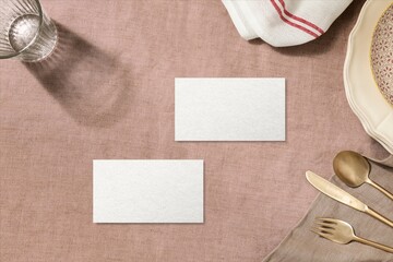 Obraz premium Blank cards on rustic table setting with plates and cutlery