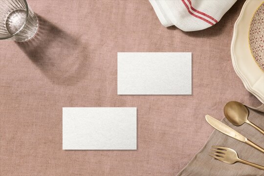 Blank cards on rustic table setting with plates and cutlery