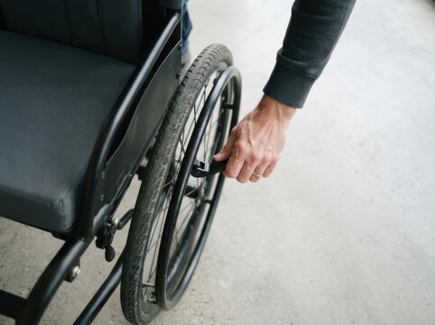 A man using a manual wheelchair indoor, focusing on disability support and mobility assistance concept