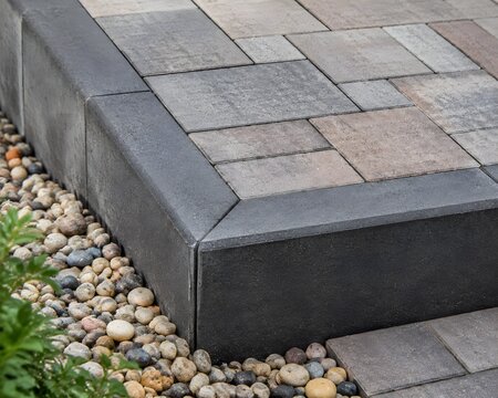 Completed Patio Retaining Edge With Crisp Concrete Finish And Perfectly Laid Paving Professional Construction Detail