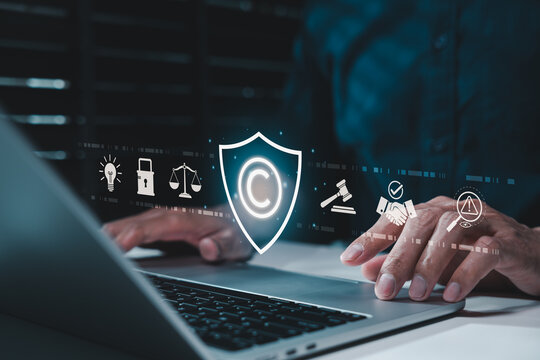 Copyright protection concept. Person using laptop and copyright icon with legal, security, and intellectual property symbols, representing creative rights, trademark law and digital content ownership.