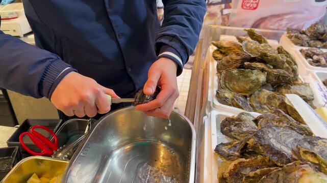 Chef shucking fresh oysters at a bustling seafood market, showcasing culinary skills and fresh ingredients.