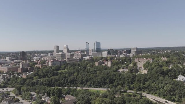 Aerial Reveal of White Plains Neighborhood and Distant City Skylin