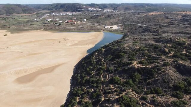 Aerial view of Praia da Bordeira dunes and lagoon near Carrapateira, Portugal