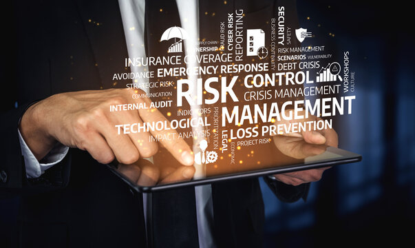 Close-up of hands holding a tablet with visual representation of risk management keywords, showcasing essential concepts in crisis control and loss prevention strategies. Tessel