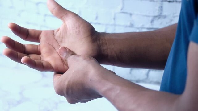 Person massaging painful hand experiencing discomfort and agony