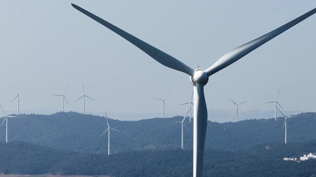 Wind turbines on rolling green hills generating clean energy
