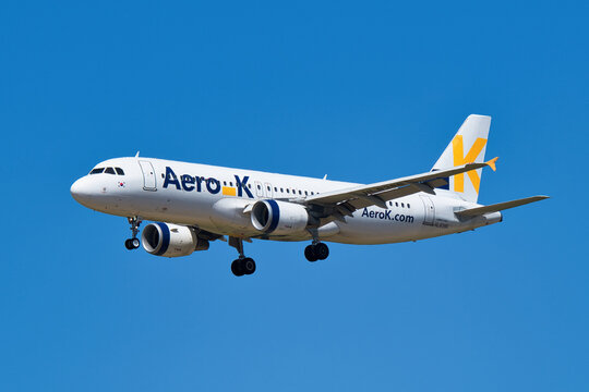 Aero K Airbus A320-200 (HL8386) passenger plane approaching Narita International Airport for landing under clear blue sky