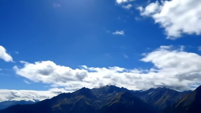 Mountain range under blue sky, fluffy clouds. Background distant peaks. Use travel, nature
