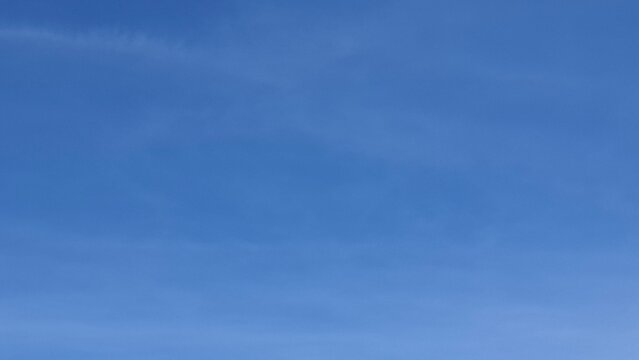 Bright blue cloudless sky on a clear sunny day, creating a clean and minimal natural background.