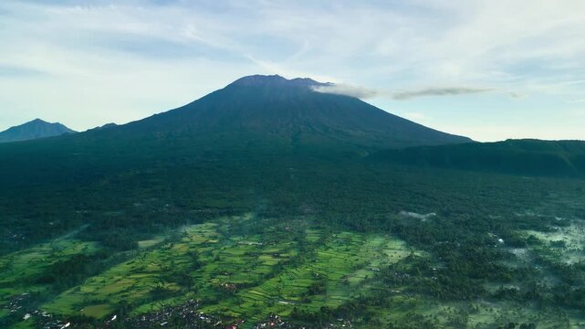 Mount Agung Volcano Overriding Green Rice Fields in Bali