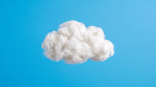 A single fluffy white cloud shape made of soft cotton on a bright blue background, minimalist and metaphorical.