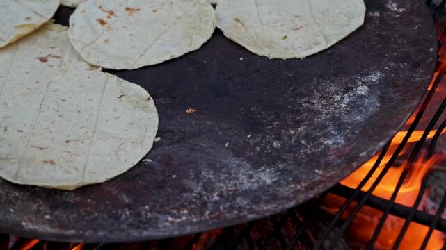 Traditional Corn Tortillas Cooking On Comal Over Open Wood Fire In Rural Mexico