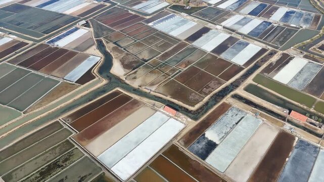Aerial View of Colorful Geometric Salt Evaporation Ponds and Aquaculture Farms
