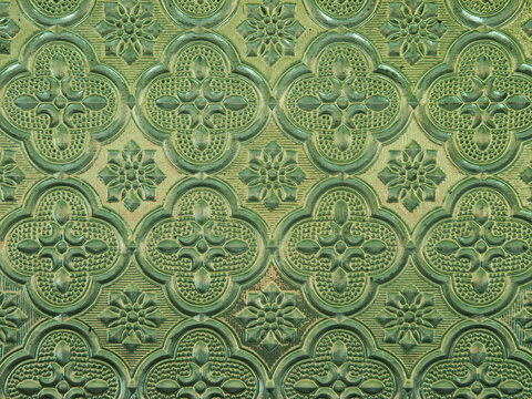 Seamless vintage green embossed glass textured background with classic geometric floral repeating pattern
