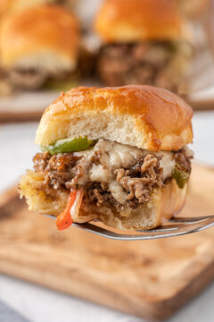 Philly cheesesteak slider on a fork, party food and catering concept, gourmet appetizer with melted cheese and peppers for casual dining and events