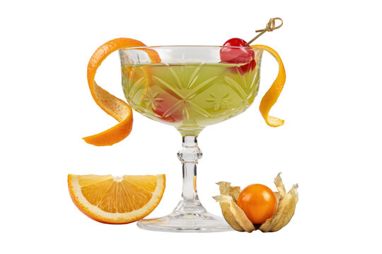 Green cocktail in a crystal coupe glass garnished with orange peel and maraschino cherry with physalis fruit isolated on a transparent background