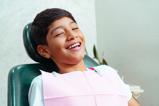 Little boy laughing during dental check up