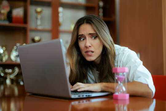 Confused Multitasking Entrepreneur Working on Laptop, Tablet and Phone Simultaneous. Pensive businesswoman feeling uncertain about information and fake news