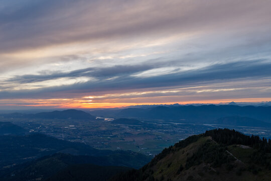 Sunset Over Mountains And Valley From Elk Mountain Near Chilliwack BC Canada With Layered Clouds