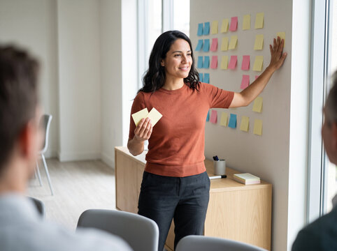 Latina consultant in her 30s facilitating a strategy workshop