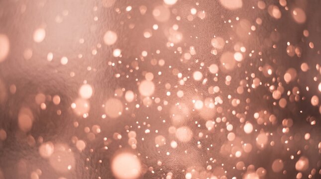 Abstract background featuring soft glowing rose gold bokeh lights with a dreamy and elegant festive atmosphere
