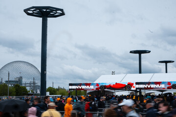 Fototapeta premium May 24, 2026, Montreal, Canada, F1 fans walk near the Canadian Grand Prix entrance at Parc Jean-Drapeau. g.