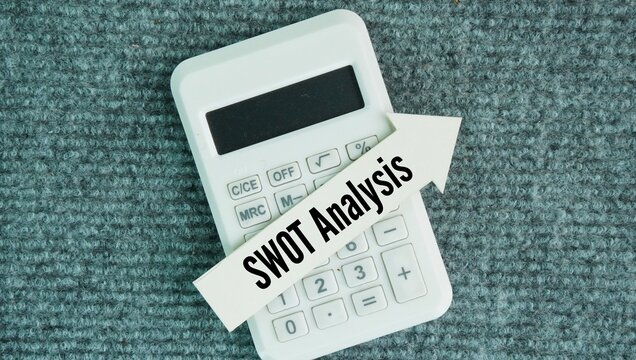 Calculator and arrow with the word SWOT Analysis. strategic framework used to assess a business's internal strengths and weaknesses and external opportunities and threats