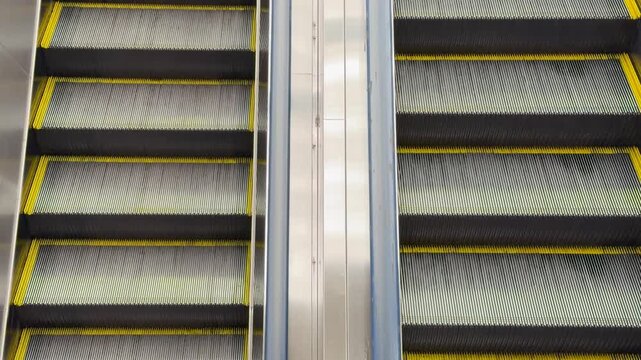 Closeup view of moving escalator steps with yellow safety lines for transportation.