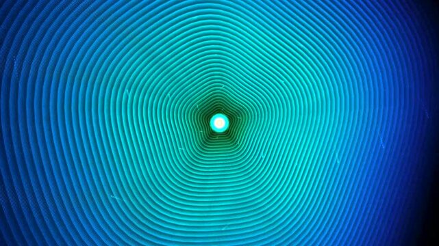 Abstract background with circular ripple patterns in vibrant blue and green gradient colors creating a hypnotic tunnel effect for modern digital art and design projects 4k Motion Video