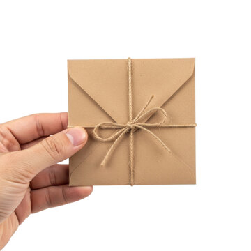 Hand holding brown kraft paper envelope with twine