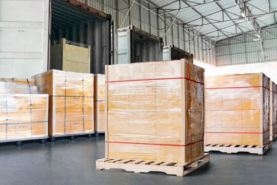 Goods awaiting loading into shipping containers. bulk of package boxes shipment. freight transportation logistics. distribution warehouse, import-export shipment. warehouse logistics
