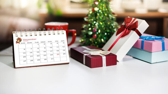 close-up shot, calendar on december 2026 with christmas holiday on 25 before start new year 2027 with gift box and christmas background. Celebration of New Year 2027 concept