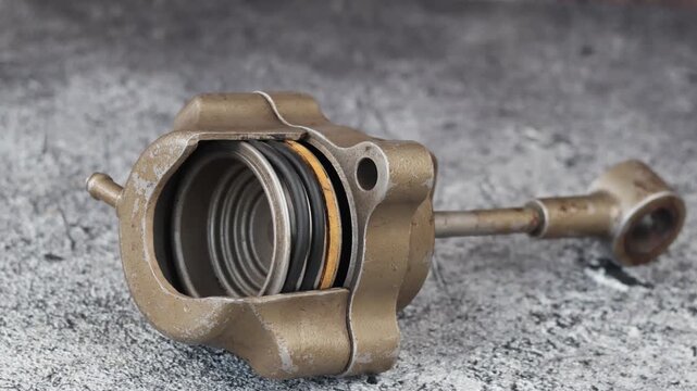 Panning shot of Cutaway pneumatic actuator displays internal coil spring and diaphragm for turbocharger boost control.