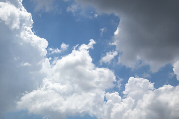 Fototapeta premium fluffy white clouds building up in the light blue sky
