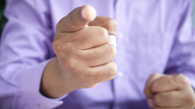 Man in purple shirt points finger accusingly, close-up shot, dynamic hand gesture, instructional motion
