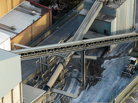 Industrial conveyor systems and aggregate processing equipment at a concrete batching plant, showing automated materials handling infrastructure for concrete production