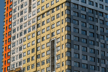 Fototapeta premium Modern architectural marvel showcasing vibrant colors and unique design elements in a lively urban area during the bright afternoon