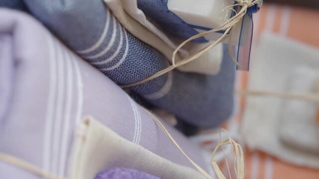 Close up of carefully wrapped gift sets of natural soap, pumice stone, and hammam towels presented for sale