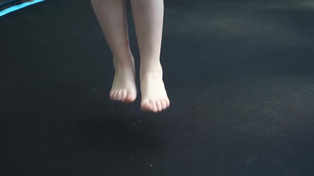 Child jumping on an outdoor trampoline in a play area