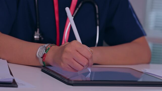 Medical Professional Writing Clinical Healthcare Documentation on Digital Tablet at Desk with Stethoscope and Wristwatch, Focused Medical Technology Workspace Scene